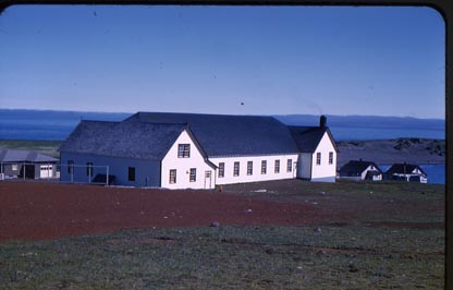 Photo of the recreation hall, a large white building.
